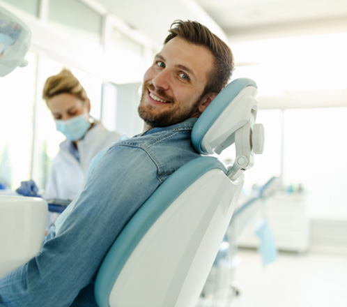 Man smiling while sitting in treatment chair
