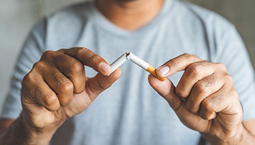 Man breaks cigarette