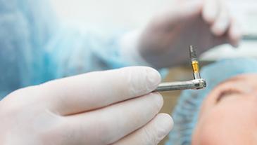 patient getting dental implant during surgery 