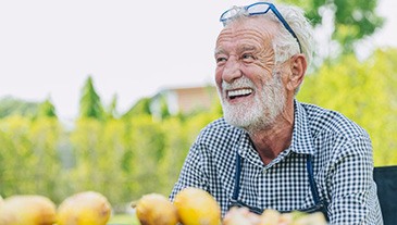 Man laughs outdoors