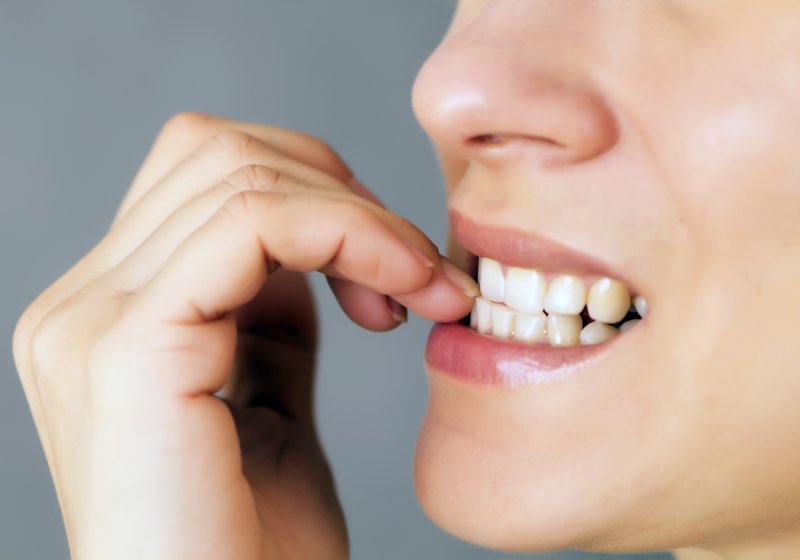 Woman biting her nails