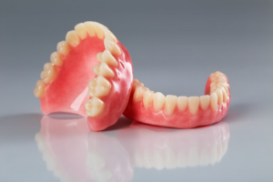 Two sets of dentures on a milky white background